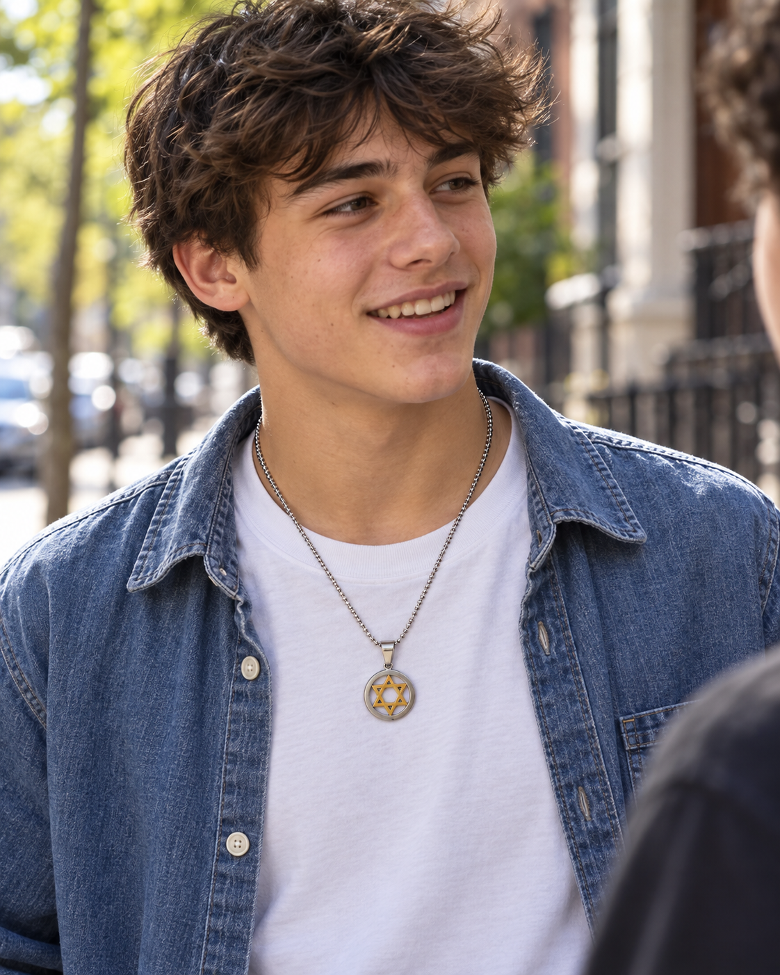 Young man wearing the two-tone Star of David necklace with a denim shirt