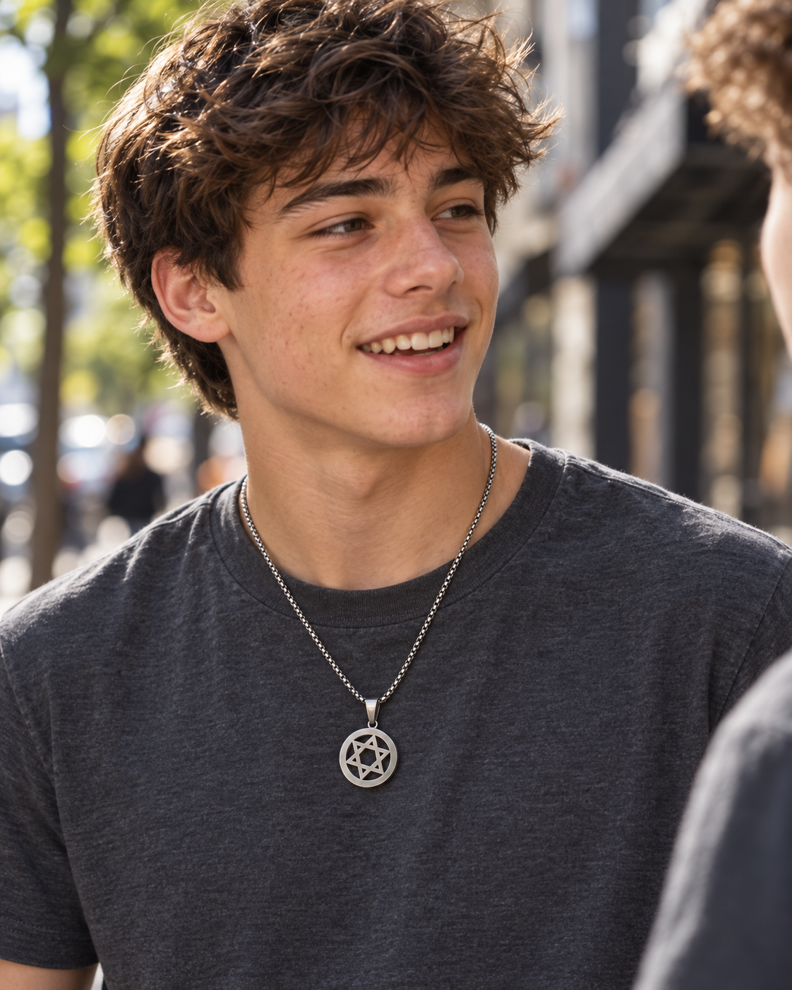 Young man wearing the silver Open Star of David necklace