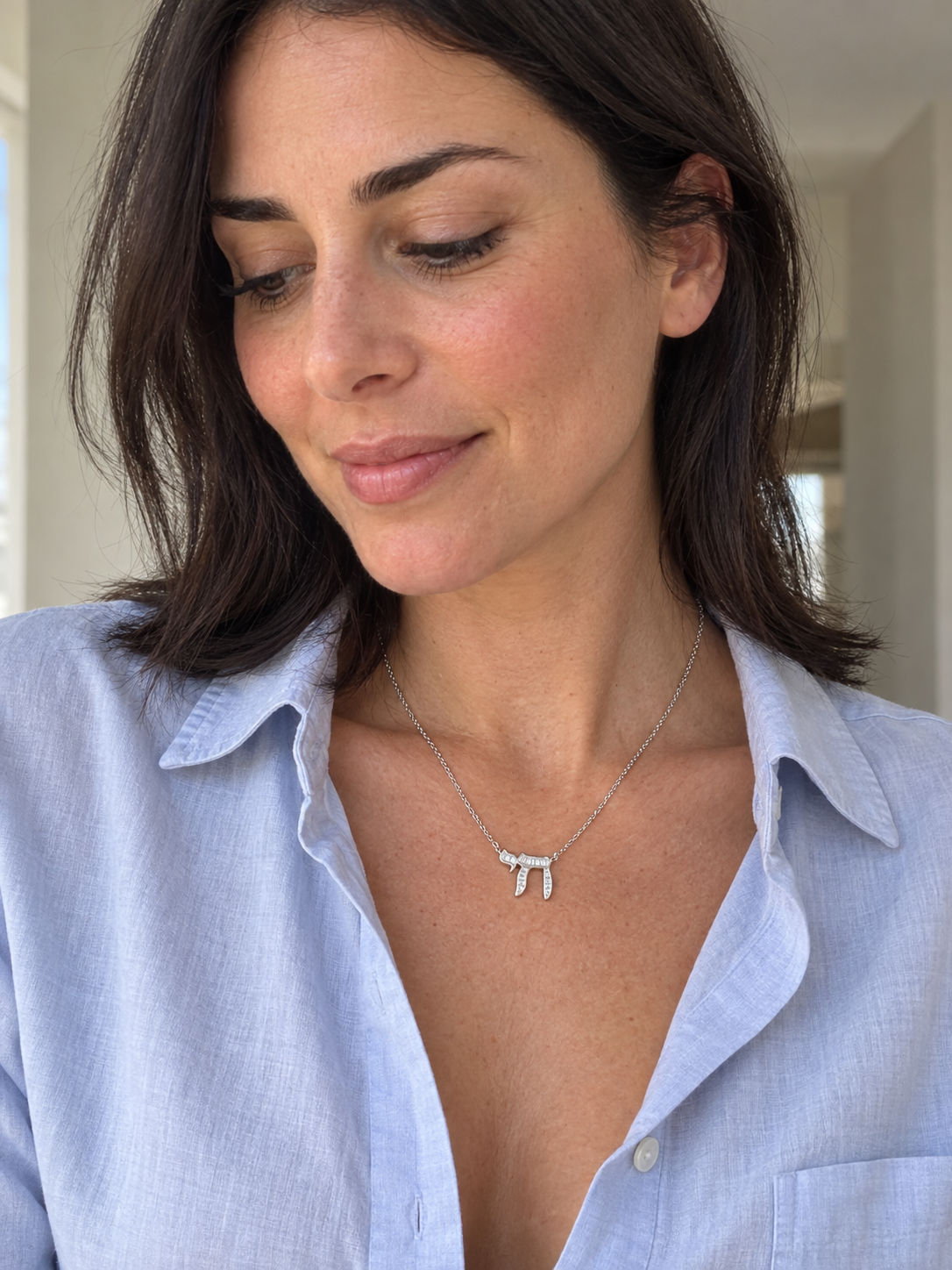 Model wearing the sterling silver baguette Chai necklace